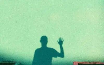 Man waving in shadow 